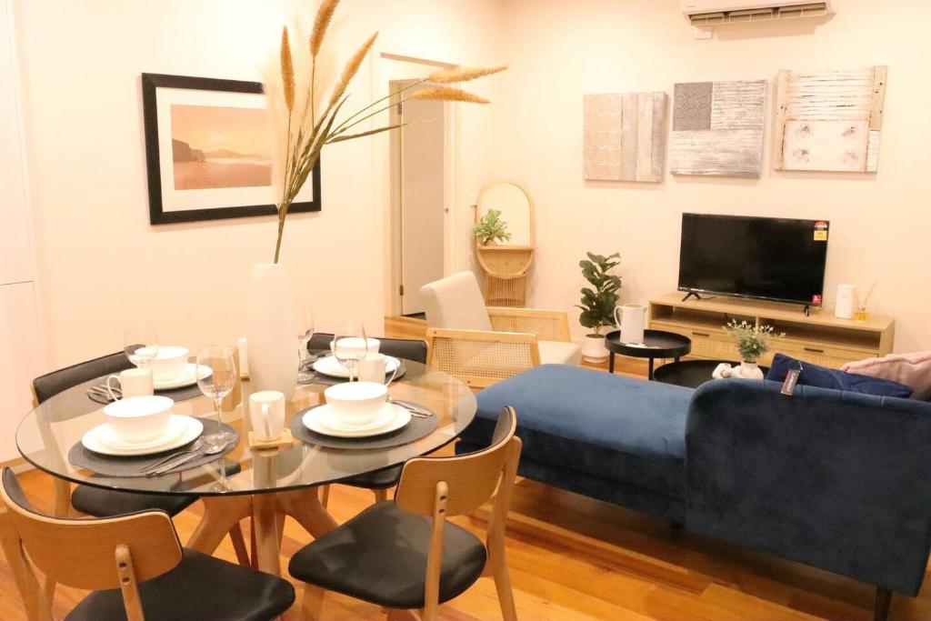 a living room with a blue couch and a table at Footscray home just 7km away to Melbourne CBD newly stylist setup in Melbourne