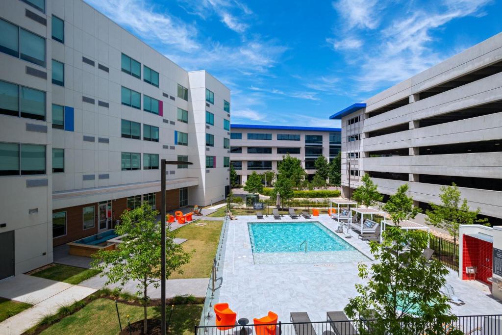 an image of an apartment complex with a swimming pool at Aloft Austin Southwest in Austin