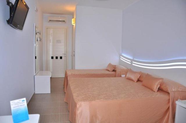 Postel nebo postele na pokoji v ubytování Hotel Perla Dello Ionio