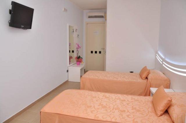 Postel nebo postele na pokoji v ubytování Hotel Perla Dello Ionio