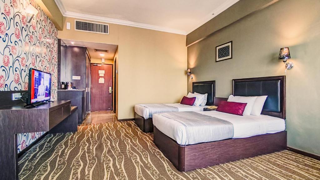 Postel nebo postele na pokoji v ubytování New York Hotel
