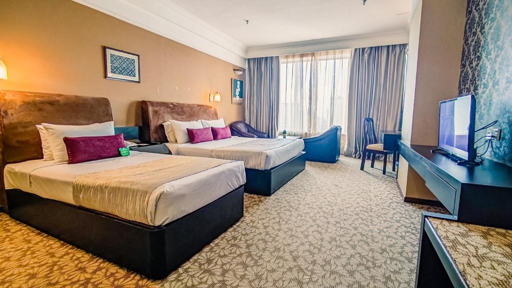 Postel nebo postele na pokoji v ubytování New York Hotel