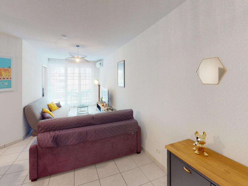 a living room with a couch and a table at Appartement Menton, 2 pièces, 4 personnes - FR-1-196-336 in Menton