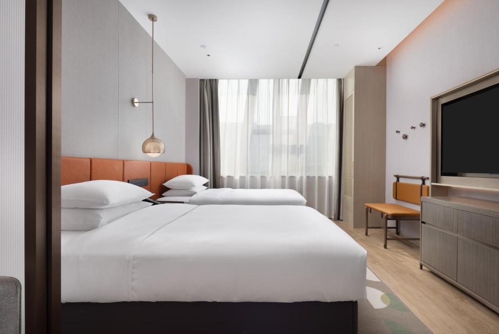 Postel nebo postele na pokoji v ubytování Home2 Suites by Hilton Beijing Shunyi