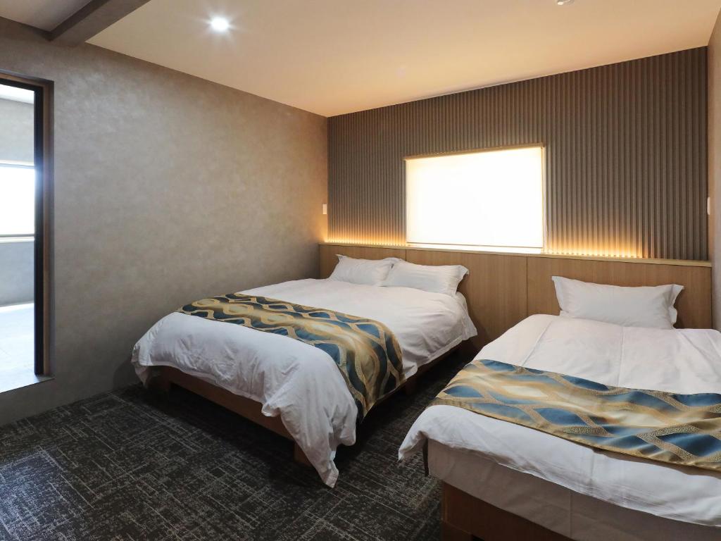 Postel nebo postele na pokoji v ubytování Kurobe Sunvalley Hotel