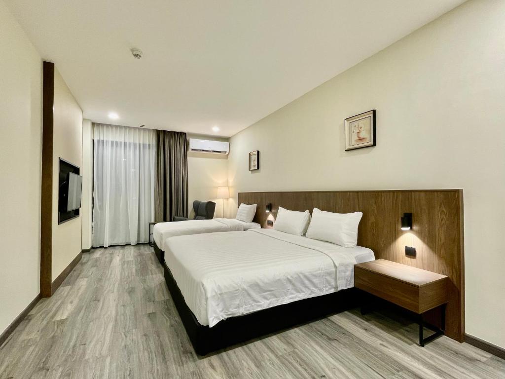 Postel nebo postele na pokoji v ubytování Hotel Bundusan