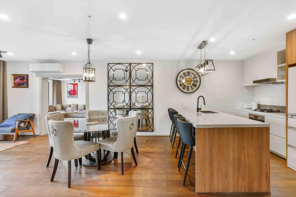 a kitchen and living room with a table and chairs at Home*walking Chadstone shopping centre in Chadstone