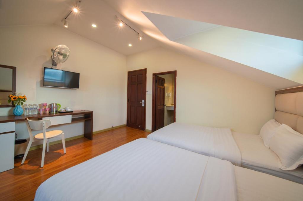 Postel nebo postele na pokoji v ubytování Tasme Hotel