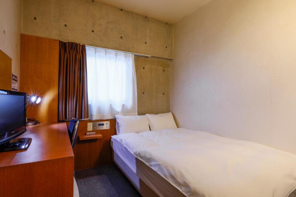 Postel nebo postele na pokoji v ubytování Hotel Landmark Umeda
