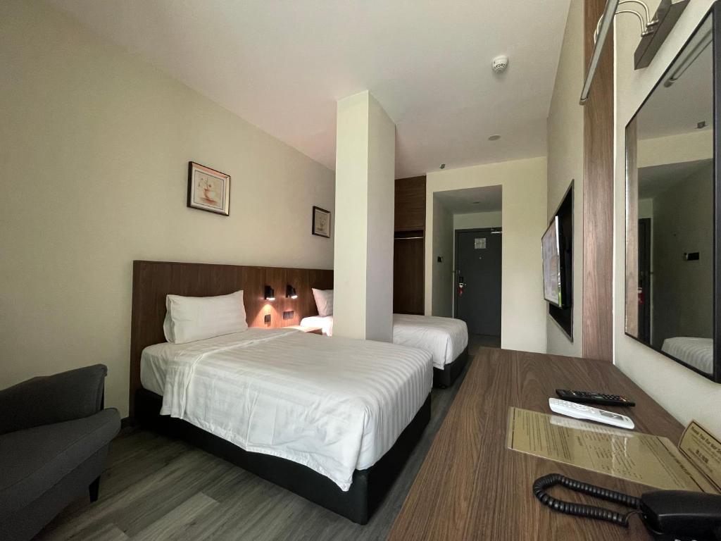 Postel nebo postele na pokoji v ubytování Hotel Bundusan