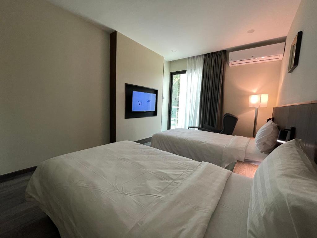Postel nebo postele na pokoji v ubytování Hotel Bundusan