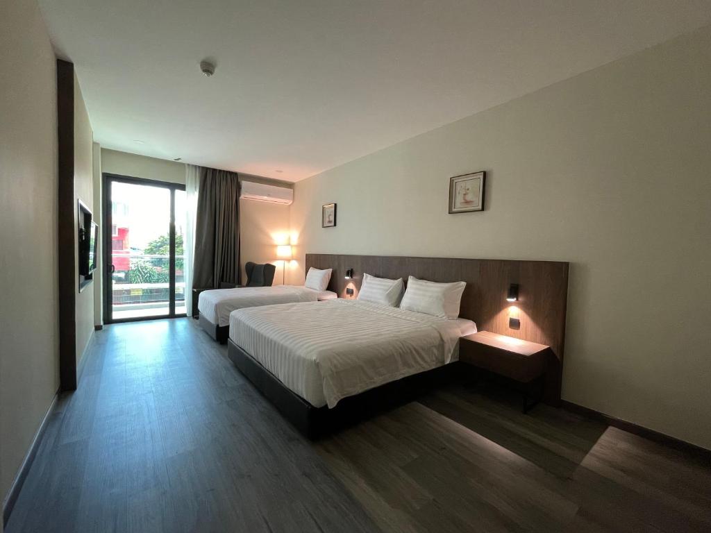 Postel nebo postele na pokoji v ubytování Hotel Bundusan