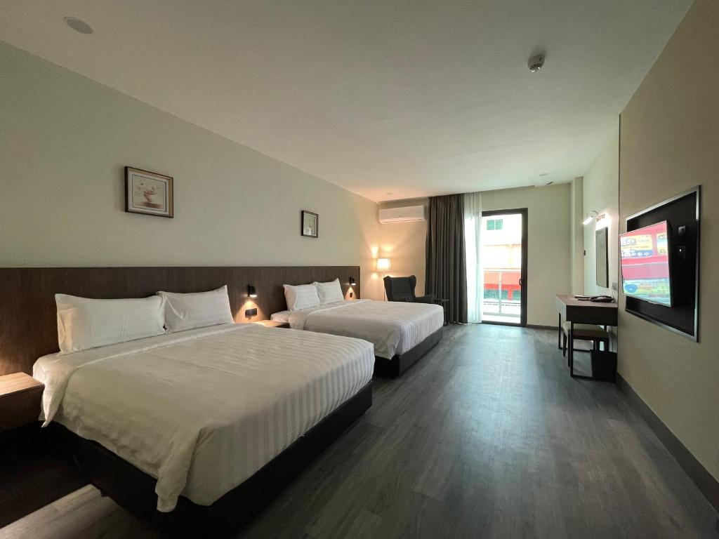 Postel nebo postele na pokoji v ubytování Hotel Bundusan