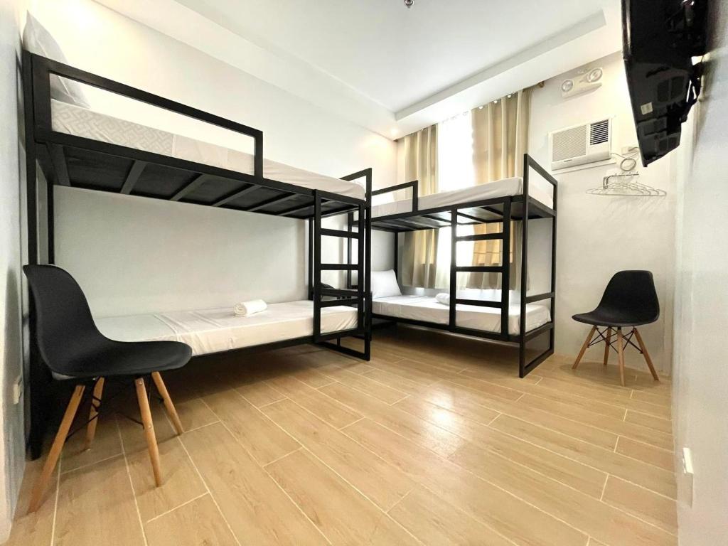 Postel nebo postele na pokoji v ubytování Bambu Suites