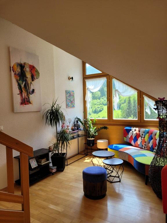 a living room with a couch and some windows at green hill in Bad Kleinkirchheim