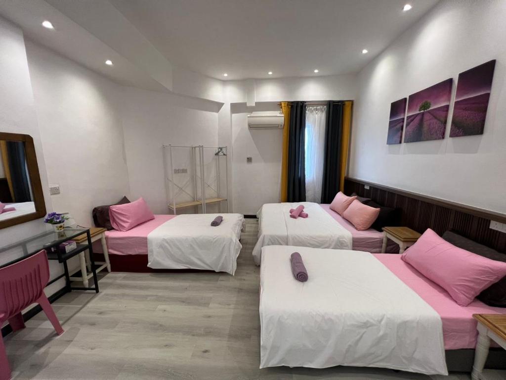Postel nebo postele na pokoji v ubytování One Point Inn King Centre