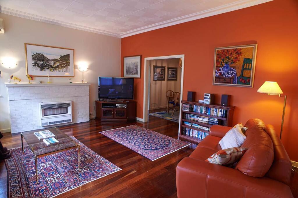 a living room with a couch and a fireplace at Asrama Albany in Albany