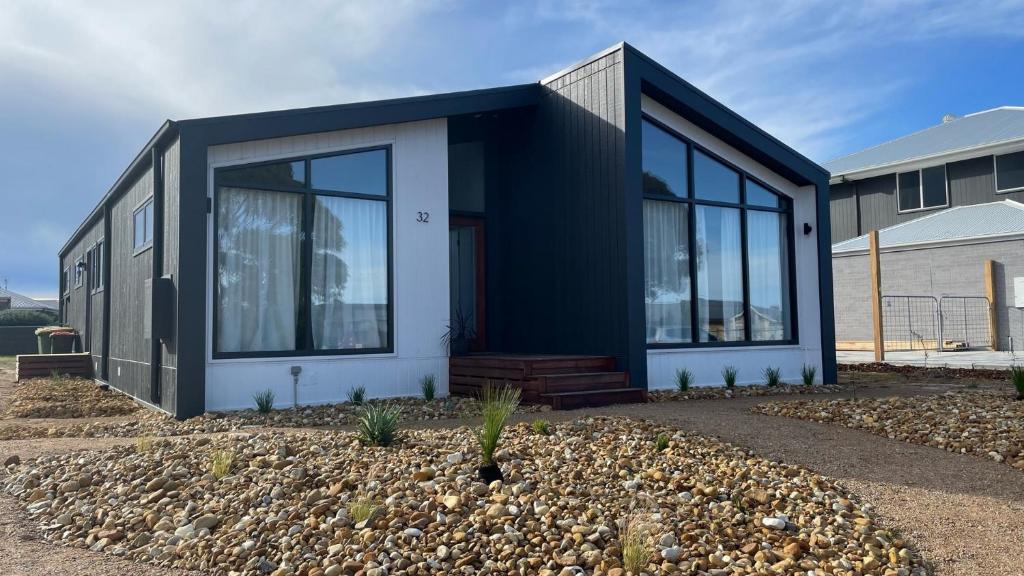 a black and white house with glass windows at 32 Plateau in Metung