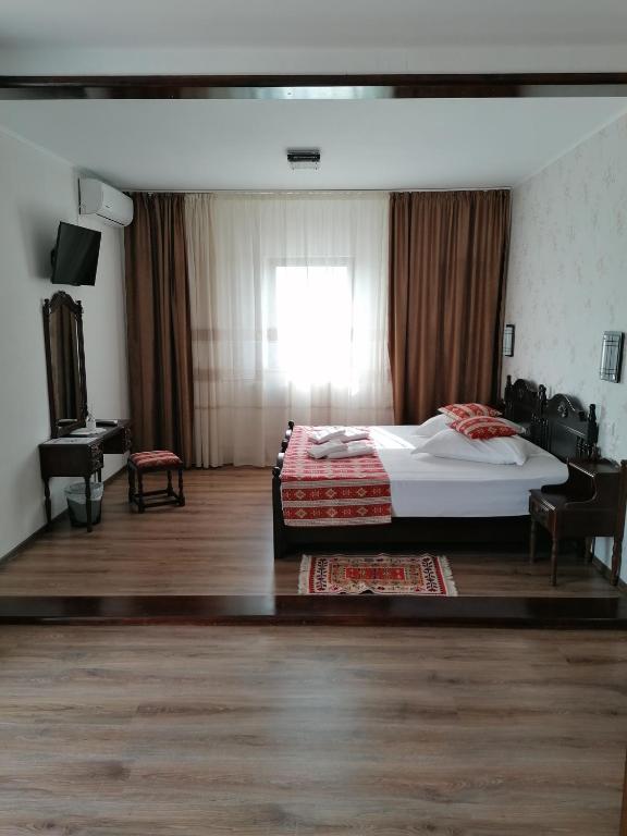 Postel nebo postele na pokoji v ubytování Hanul Hora Romaneasca
