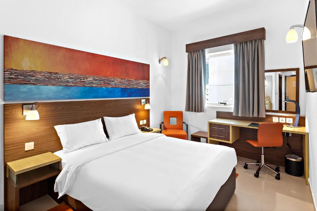 a hotel room with a bed and a desk at Citymax Hotel Bur Dubai in Dubai