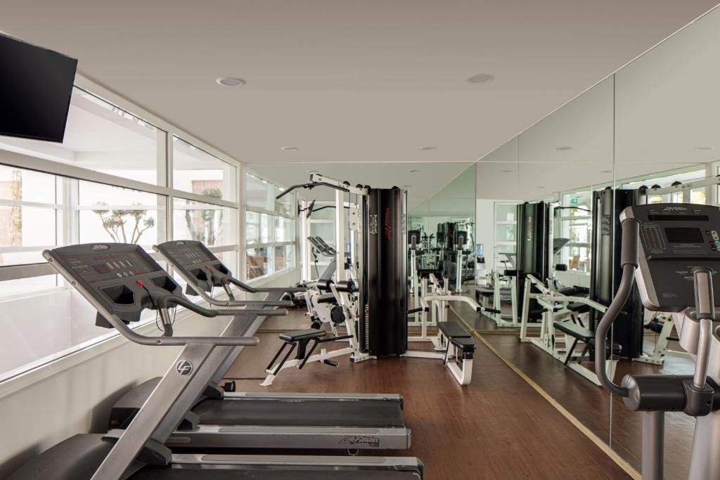 a gym with treadmills and ellipticals in a building at Doria Hotel Bodrum-City Center in Bitez