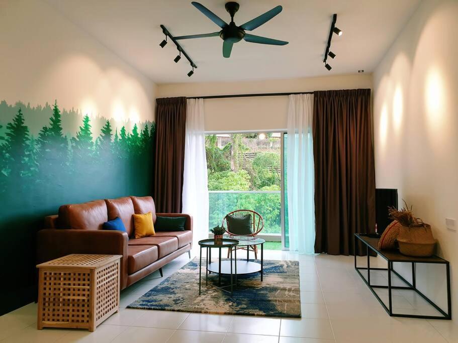 a living room with a couch and a ceiling fan at ForestNest Cameron Town Spacious 3R3B (1300 sqft) in Tanah Rata