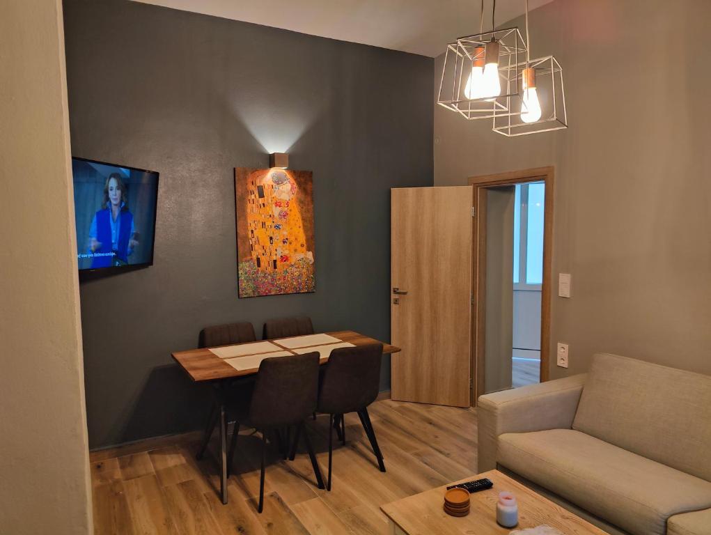 a living room with a table and a couch at Deluxe Center Apartment - Preveza in Preveza