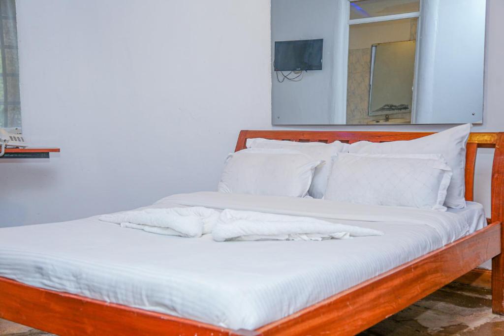 Postel nebo postele na pokoji v ubytování Dovenest Lodge