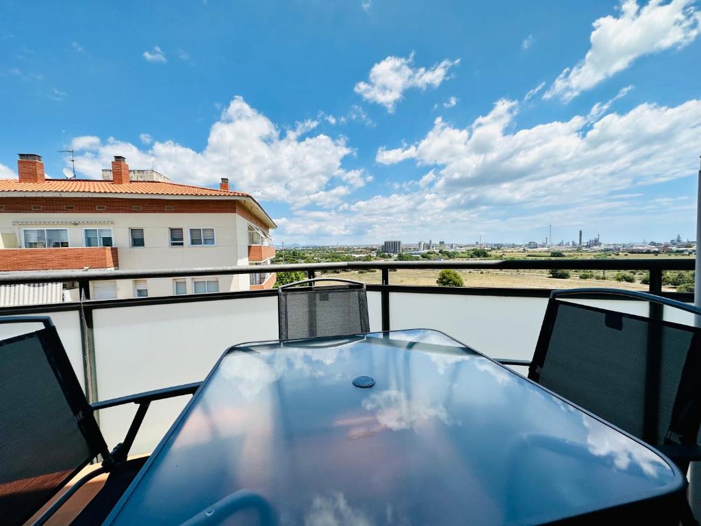a glass table on a balcony with a view at BOOK VILA-SECA TOWN in Vilaseca de Solcina