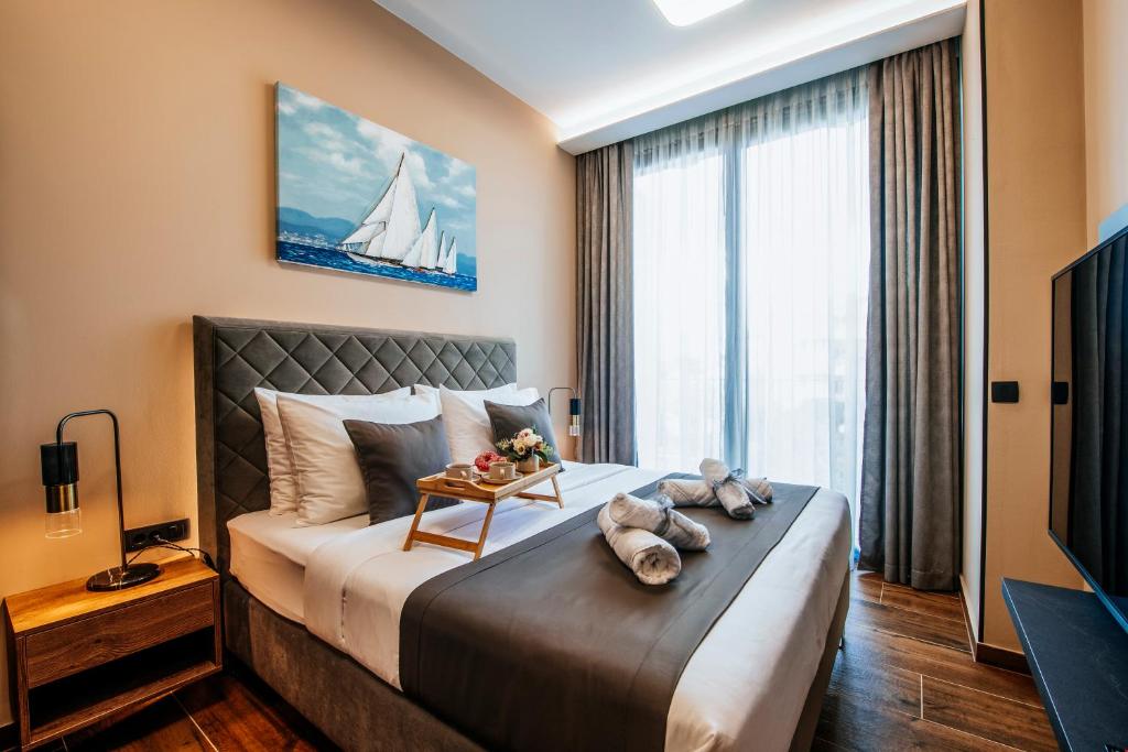 a bedroom with a large bed with a sailboat on it at Dedaj Resort - Villa Almaro in Zadar