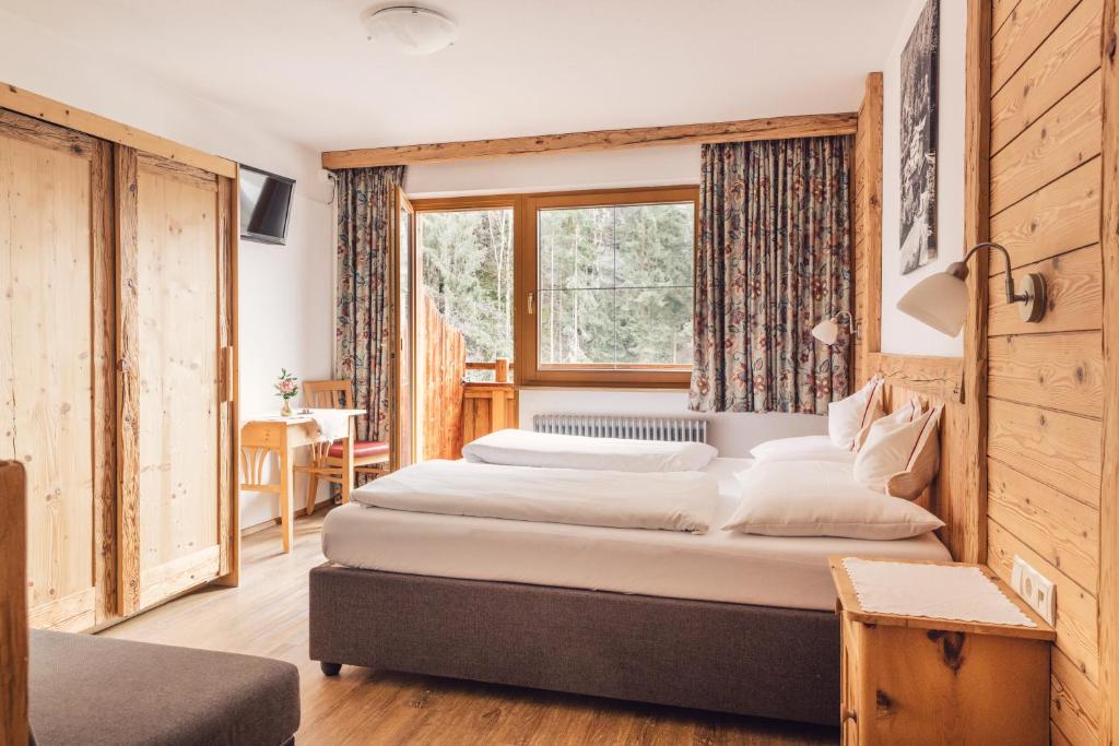 a bedroom with two beds and a window at Bed & Breakfast Hotel Märzenklamm in Stumm