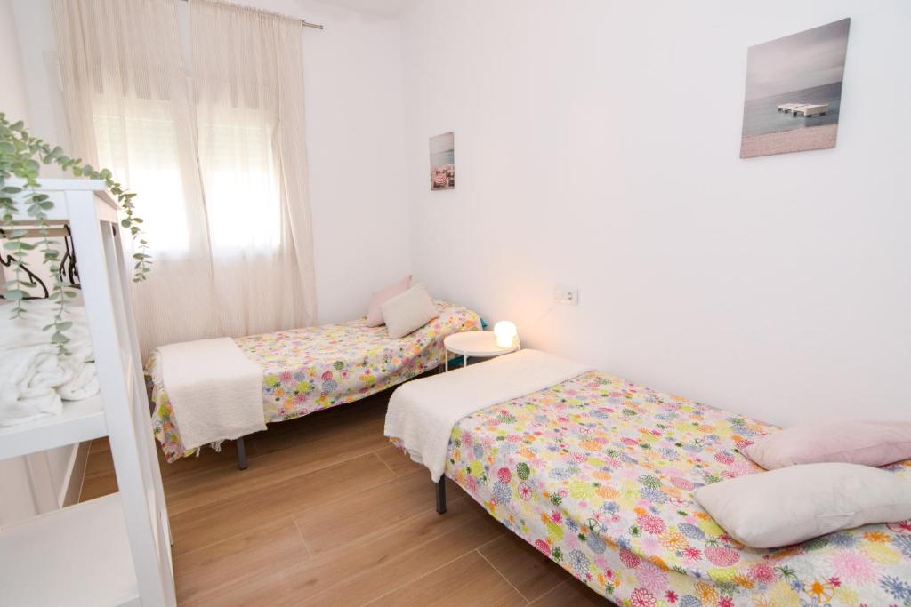 Postel nebo postele na pokoji v ubytování Apartamentos Atlantida