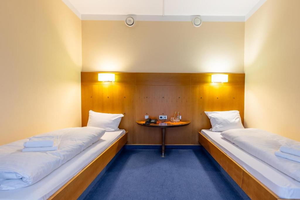 Postel nebo postele na pokoji v ubytování Dresdner Tor Süd
