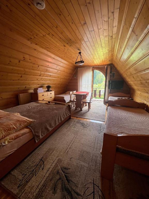 una camera con un letto e un tavolo in una cabina di u Winicjusza a Nowy Targ