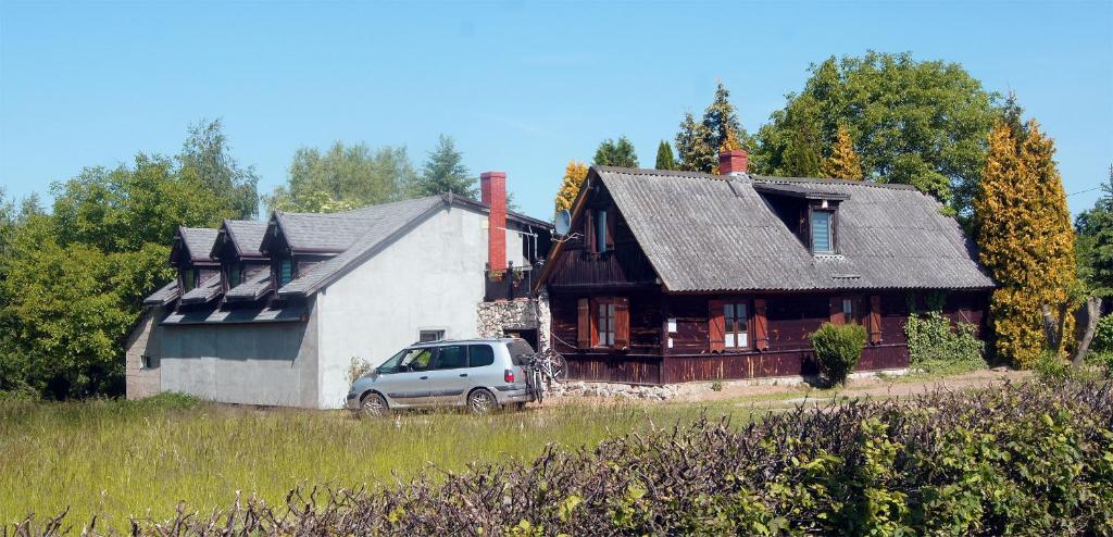 uma carrinha estacionada em frente a uma casa em Agroturystyka Camp4x4 em Nosów