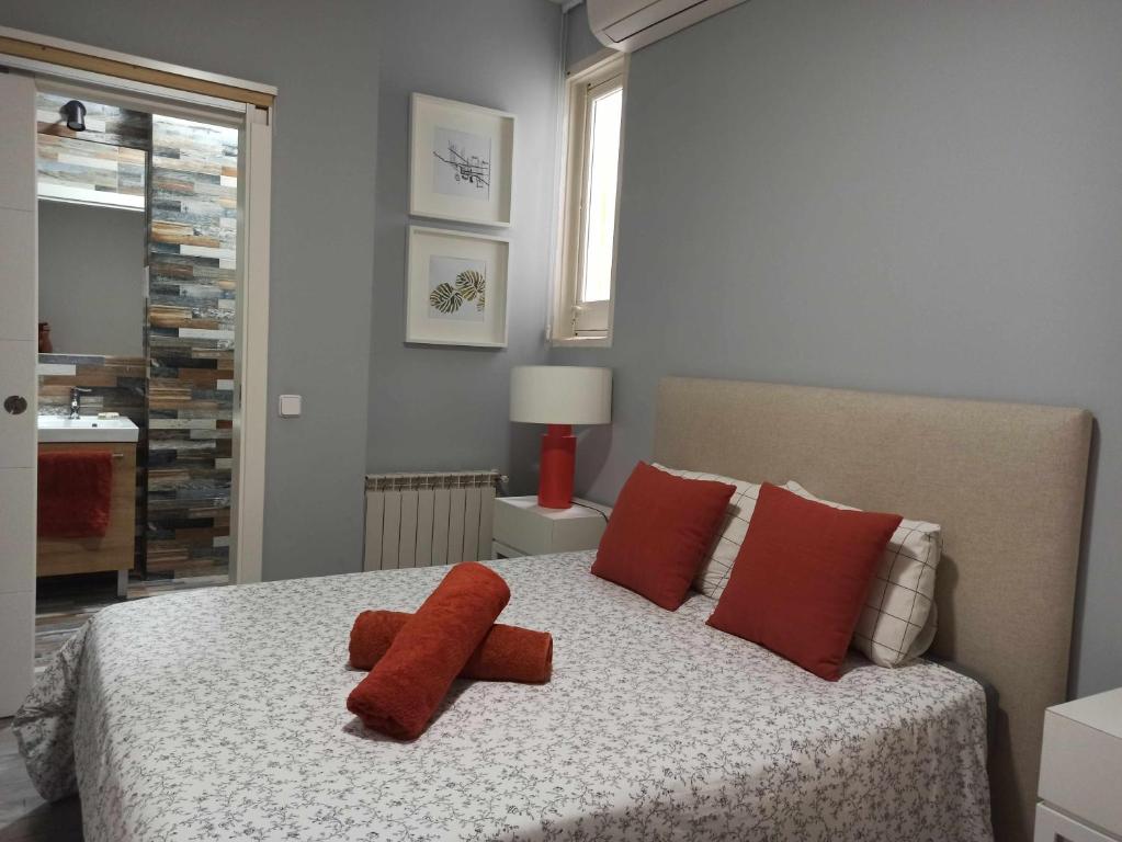 - une chambre avec un lit et 2 oreillers rouges dans l'établissement Familiar Centro de Madrid Plaza de España, à Madrid