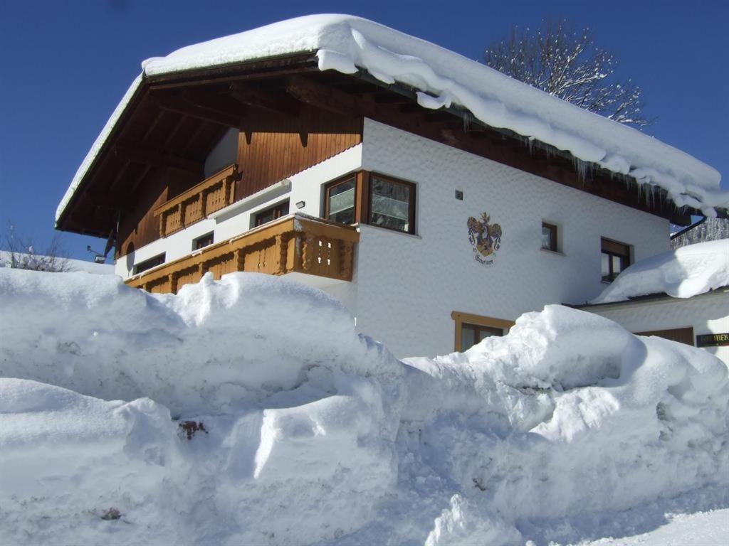 a pile of snow in front of a house at Haus Anita in Wald am Arlberg