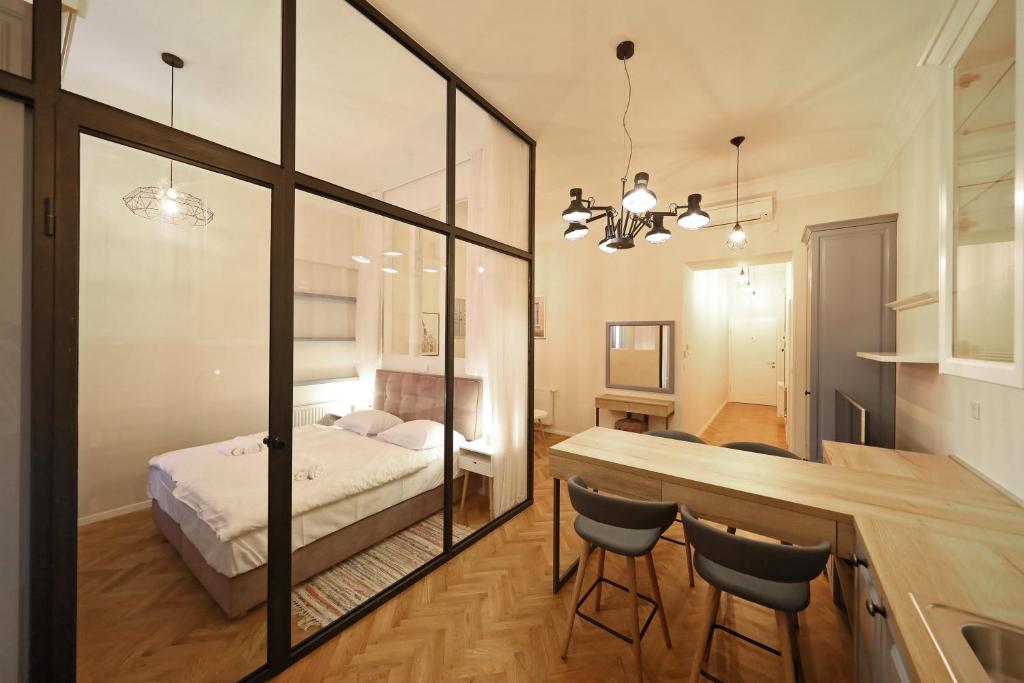 a bedroom with a bed and a table and chairs at Stay Swanky Bed & Breakfast in Zagreb