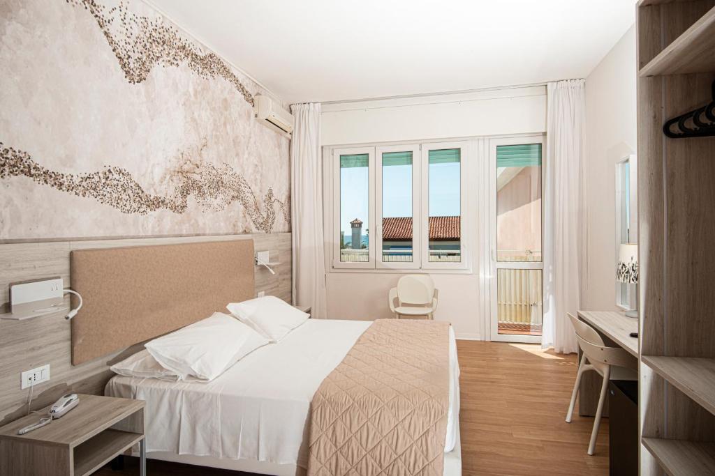 Postel nebo postele na pokoji v ubytování Hotel Splendid