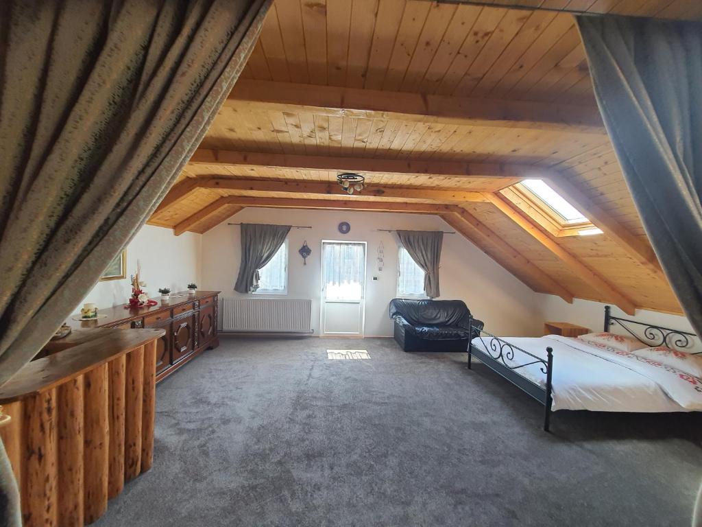 a large attic room with a bed and a couch at Casa Meli in Borsa