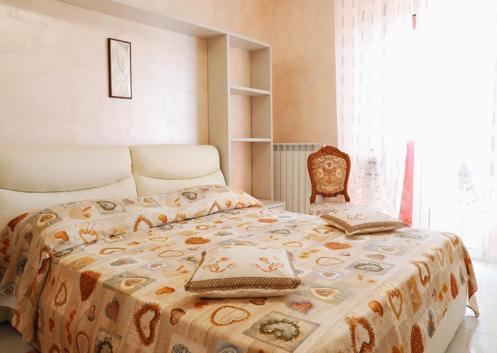 a bedroom with a bed and a chair at Villa Largo Belvedere in Campomarino