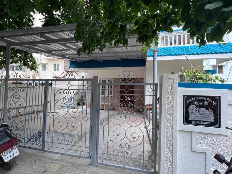 a gate in front of a house with a building at 2BHK with parking & ample space in Bangalore