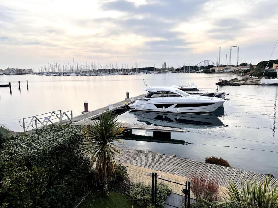 a boat is docked at a dock in the water at VILLA D'EXCEPTION - MARINA PISCINE ROOFTOP 10 PERSONNES - 4 Etoiles in Cap d'Agde