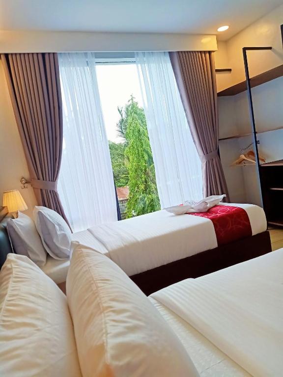 Postel nebo postele na pokoji v ubytování INNCITY HOTEL