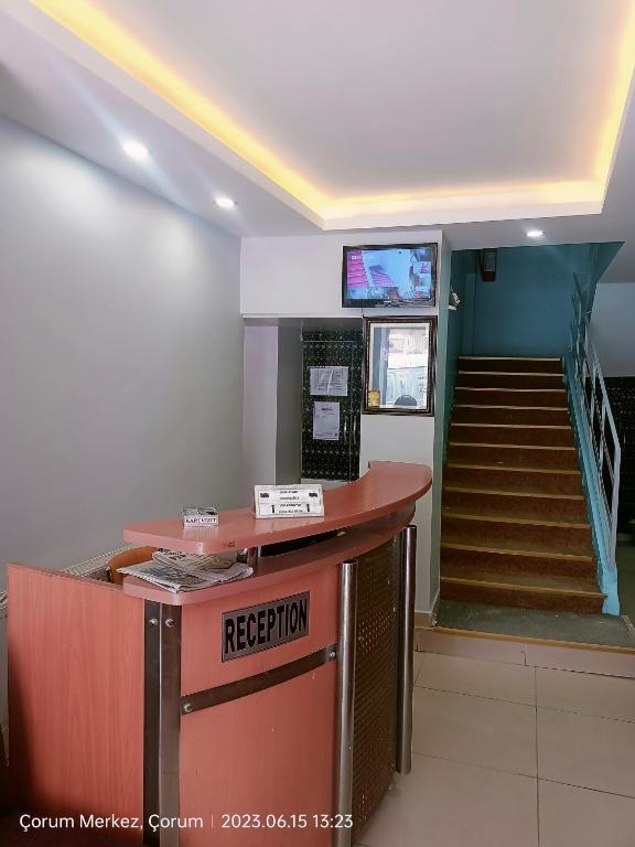 a lobby with a reception counter and a staircase at Şirin Apart in Corum