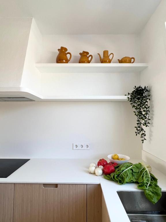A kitchen or kitchenette at BiniVento- Lovely villa with pool near the beach