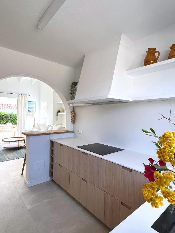 A kitchen or kitchenette at BiniVento- Lovely villa with pool near the beach