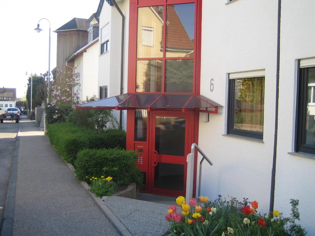 una puerta roja en el lateral de un edificio en Ferienwohnung Klenk en Ostfildern