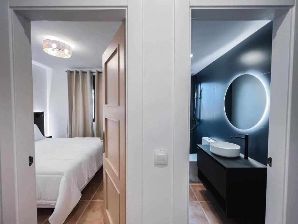 Postel nebo postele na pokoji v ubytování Nido Baeza Suites
