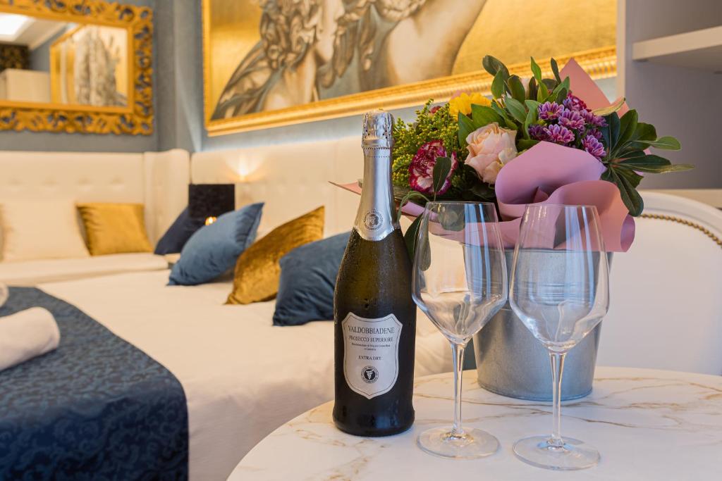 a bottle of wine and two glasses on a table at Royal Verona Relais in Verona